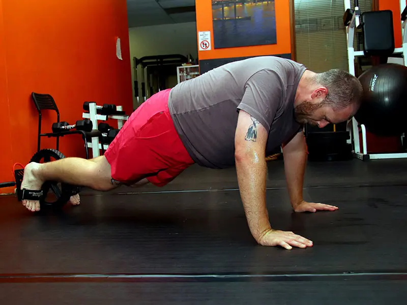 Strength & Conditioning instructor coaching student with focus mitts during fitness training in Portland gym